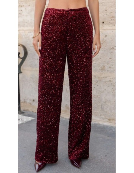 Traje de chaqueta en lentejuelas compuesto por chaqueta entallada y boton metalizado combinado con pantalón palazzo y bolsillos