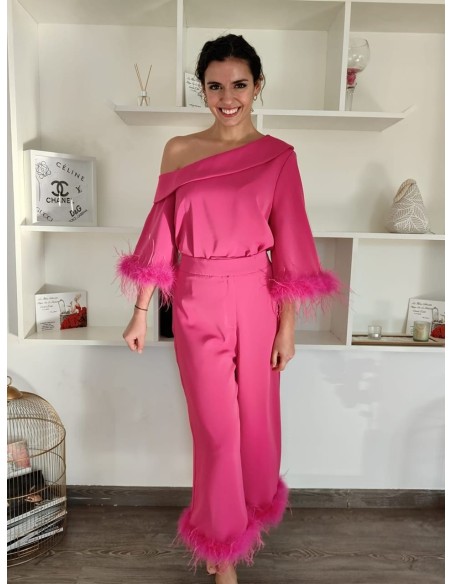 Conjunto de camisa con escote asimétrico y pantalón cropped de trio alto. Detalle de plumas en mangas y bajos de pantalón.