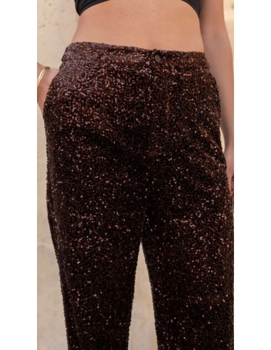 Traje de chaqueta en lentejuelas compuesto por chaqueta entallada y boton metalizado combinado con pantalón palazzo y bolsillos