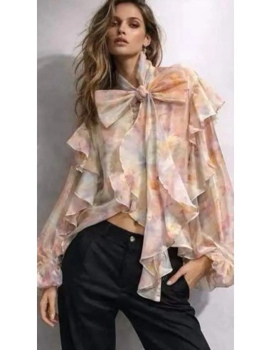 Camisa oversize con estampado floral y detalle de volantes y lazada en el cuello.