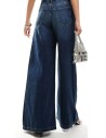 Jeans de tiro alto palazzo en tejido azul oscuro y cinco bolsillos. Tejido elástico.